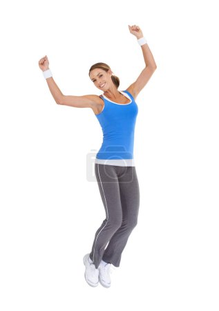 Photo for Woman, jump and fitness celebration in studio for exercise success, workout achievement or body goals and dance. Sports model with fist, energy and portrait for training results on a white background. - Royalty Free Image