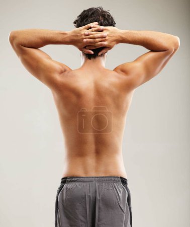 Photo for Back, topless or man for fitness results, wellness and health isolated on grey background in studio. Hands up, model or male person with progress in exercise, workout and training on a backdrop alone. - Royalty Free Image