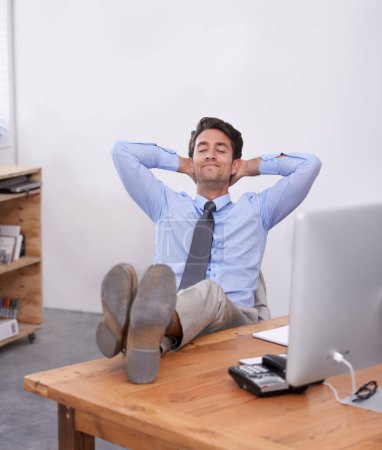 Photo for Nap, relax or happy man in office on break for mental health, pride or wellness at his desk or workplace. Calm, business or employee sleeping with smile or hand behind his head stretching or resting. - Royalty Free Image