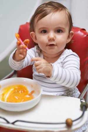 Photo for Baby, high chair and food in bowl for meal, nutrition or healthy porridge with spoon at home. Portrait of young cute little child, kid or toddler playing with snack for hunger, vitamins or nutrients. - Royalty Free Image