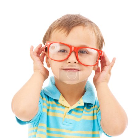 Photo for Child, boy and frames or glasses in studio, eyes and vision support by white background. Male person, kid and ophthalmology for eyecare, red spectacles and stylish fashion by backdrop for wellness. - Royalty Free Image