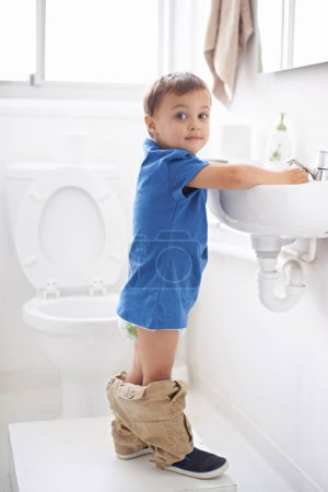 Photo for Child, boy and washing hands in portrait, hygiene and prevention of germs or bacteria in bathroom. Male person, kid and crazy humor or funny joke while potty training, cleaning and sanitary care. - Royalty Free Image