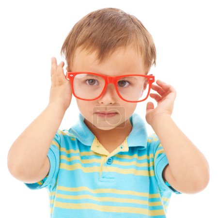 Photo for Child, boy and cool frames or glasses in studio, eyes and vision support by white background. Male person, kid and ophthalmology for eyecare, red spectacles and stylish fashion by backdrop for fun. - Royalty Free Image
