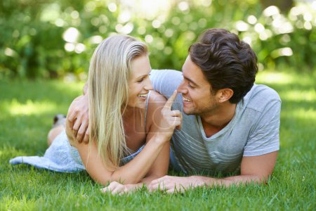 Photo for Couple, relax in park and smile with love and commitment in healthy relationship. People on grass on date outdoor, nose touch and care with trust, partner and bond together for marriage and romance. - Royalty Free Image