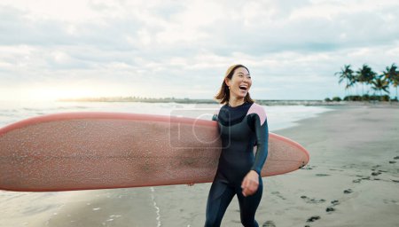 Photo for Woman, surfing board and laughing at beach, sea and ocean for summer holiday, travel adventure or hobby. Happy Japanese surfer excited for water sports, freedom or fun for tropical vacation on island. - Royalty Free Image