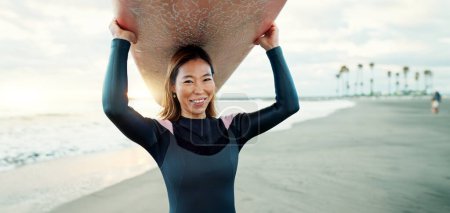 Photo for Surfing, beach and portrait of woman with surfboard for water sports, fitness and freedom by tropical ocean. Nature, travel and happy Japanese person on sand on holiday, vacation and adventure by sea. - Royalty Free Image