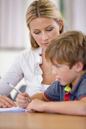 Photo for Teacher, student and help with school work in classroom, question and think of answer for education and knowledge. Teaching, learning and woman with boy in class, study and problem solving for test. - Royalty Free Image