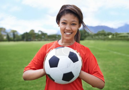 Photo for Woman, football field and portrait with ball, happy and soccer player for match, competition and game. Fitness, practice and ready for training, outdoor and exercise for athlete, fun and sport. - Royalty Free Image