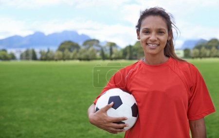 Photo for Girl, football field and portrait with ball, happy and soccer player for match, competition and game. Fitness, practice and ready for training, outdoor and exercise for athlete, fun and sport. - Royalty Free Image