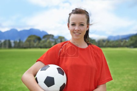 Photo for Woman, player and portrait with soccer ball, confidence and football field for match, competition or game. Fitness, practice and ready for training, outdoor and exercise for athlete, strong or sport. - Royalty Free Image