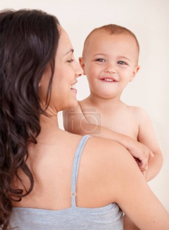 Photo for Family, happy and mother with child on a white background for bonding, relationship and relax together. Love, youth and portrait of mom carrying kid for growth, playing and development in studio. - Royalty Free Image