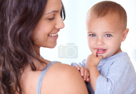 Photo for Family, happy and mother with baby on a white background for bonding, relationship and relax together. Love, youth and portrait of mom carrying kid for growth, playing and child development in studio. - Royalty Free Image