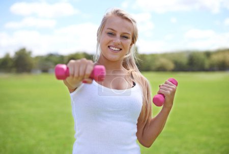 Photo for Happy woman, portrait and dumbbells for outdoor exercise, workout or training in nature. Face of young active female person or blonde smile for weightlifting, health and wellness on green grass field. - Royalty Free Image