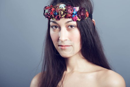 Photo for Woman, portrait and flower headband in hair with beauty, skin glow and wellness on grey background. Face, hairstyle with floral head gear or accessory, dermatology and cosmetics to blossom in studio. - Royalty Free Image