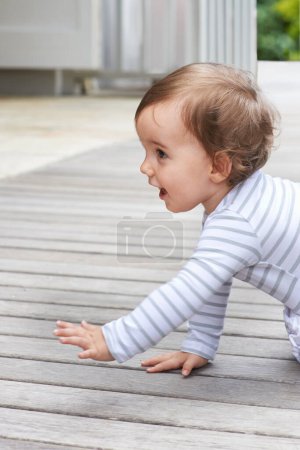 Photo for Baby, crawling outdoor and happy on floor, child development and growth with sensory, coordination and home. Girl, playing and healthy in good mood, childhood or balance with arms, kid or curious. - Royalty Free Image