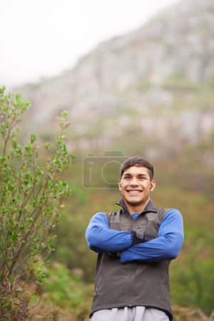 Photo for Smile, portrait and a man with arms crossed in nature for fitness, walking and exercise. Happy, morning and a male athlete or person on the mountains with pride for hiking, training or health. - Royalty Free Image