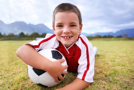 Photo for Portrait, soccer player and ball with child, smile and ready for game, field and kid. Fitness, playful and sport for childhood, happy and athlete for match, alone and outside on football pitch. - Royalty Free Image