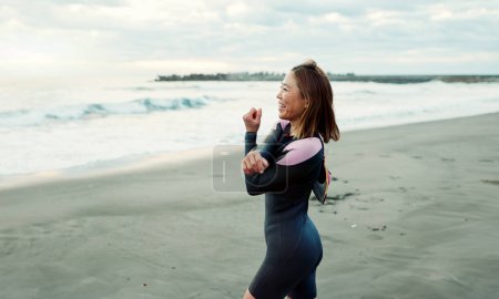Photo for Surfer, beach and woman with stretching, exercise and vacation with getaway trip, workout and training. Person, Japan and girl with ocean, waves and fitness with warm up, muscle and wellness. - Royalty Free Image