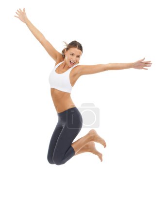 Photo for Woman, jumping and fitness in studio for exercise or wellness health or performance, mockup or white background. Female person, excited and leap or gym workout pride for balance, yoga or flexibility. - Royalty Free Image