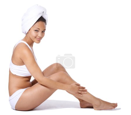 Photo for Happy woman, legs and skincare in studio portrait for hair removal results and beauty on floor on a white background. Young person or model in underwear with body cosmetics, dermatology and hygiene. - Royalty Free Image