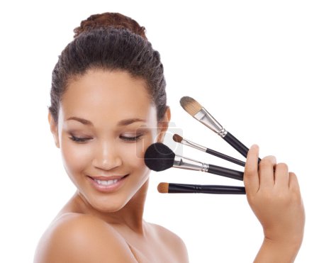 Photo for Woman, beauty and makeup brushes on face for cosmetics, skincare or blush against a white studio background. Female person or model smile for facial treatment, foundation or textures on mockup space. - Royalty Free Image