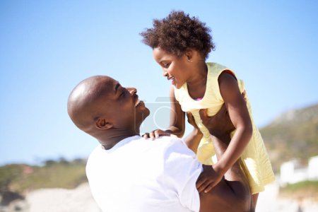 Photo for Lifting, hug and father and daughter at a beach with love, trust or support in nature together. Black family, happy and dad with girl child at the ocean for travel, fun or summer, vacation to holiday. - Royalty Free Image