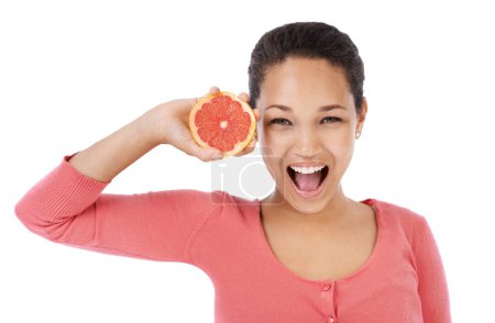 Photo for Portrait, woman and excited with grapefruit for healthy detox, vegan diet and eco nutrition in studio on white background. Model, fruits and smile for sustainable benefits of vitamin c in citrus food. - Royalty Free Image