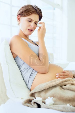 Photo for Crying, tissue and pregnant woman in a bed with depression, worry or fear for the future at home. Maternity, anxiety or person in bedroom with pregnancy mood swings, hormones or overwhelmed in house. - Royalty Free Image