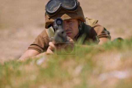 Photo for Military, shooting and aim with man and gun in nature for war, conflict and patriotism. Army, surveillance and security with person and sniper rifle training for soldier, battlefield and veteran. - Royalty Free Image