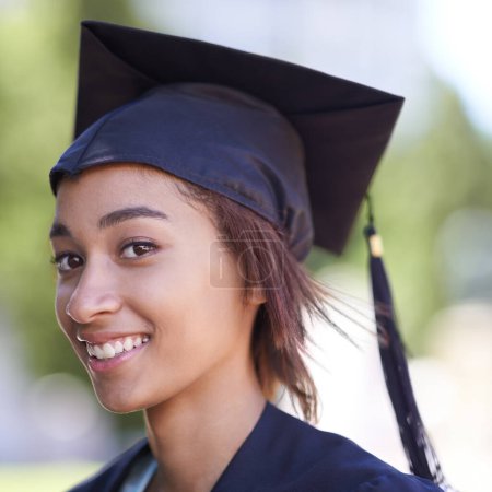 Photo for Woman, portrait with graduate and achievement with education, cap and gown for ceremony outdoor. College, smile and graduation event for academic success, higher learning and certification with pride. - Royalty Free Image