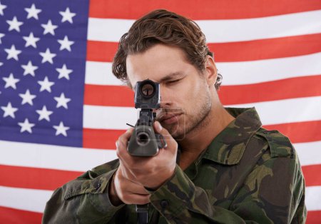 Photo for Military, aim and gun with portrait of man shooting in studio for war, conflict and patriotic. Army, surveillance and security with person on usa flag for soldier, battlefield and American veteran. - Royalty Free Image