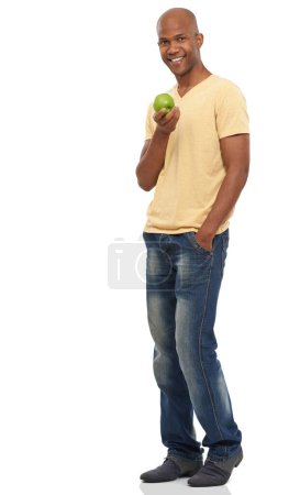 Photo for Black man, apple for nutrition, diet or detox for health with vegan life isolated on white background. Organic, fresh and green with fruit, wellness and healthy food for weight loss in studio. - Royalty Free Image