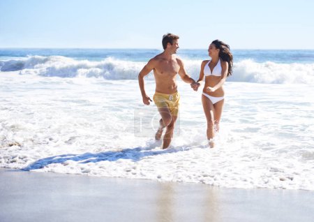 Photo for Holding hands, waves and happy couple running on beach for holiday adventure together on tropical island with care. Love, man and woman on ocean vacation with fun, romance and smile on travel in Bali. - Royalty Free Image