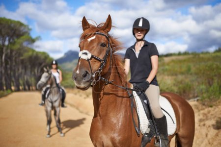Woman, horse and countryside for horseback riding in texas, rider and sport training for performance. Farm, rural and nature in outdoor, adventure and animal in gravel, pet care and dirt road.