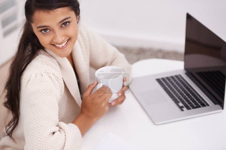 Photo for Portrait, home and woman with a laptop, coffee and smile in a living room, internet and connection. Face, person on a couch or girl in a lounge, technology and computer with daily news or digital app. - Royalty Free Image