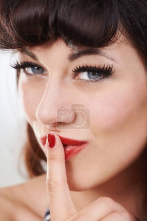 Photo for Portrait, secret and woman with finger on lips for privacy, shush or sign in studio isolated on a background. Face, girl and whisper in silence, quiet or confidential hand gesture for news of gossip. - Royalty Free Image