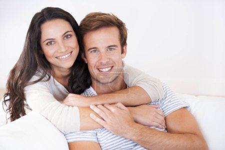 Photo for Portrait, couple hug and love, relax on sofa with trust, marriage and happy at home for healthy relationship. People bonding, loyalty and connection with smile, partner and romance together at house. - Royalty Free Image