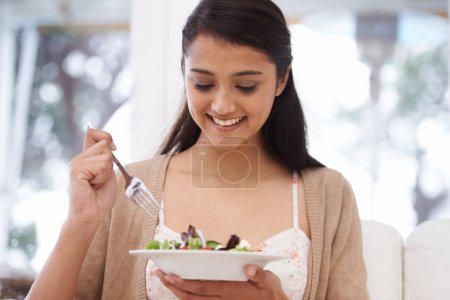 Photo for Happy woman, bowl and eating salad for diet, healthy snack or natural nutrition on sofa in living room at home. Female person, vegan or nutritionist smile with mix vegetables for weight loss at house. - Royalty Free Image