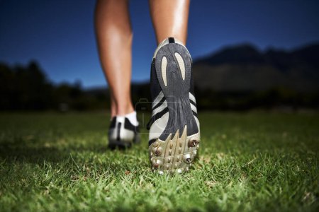 Photo for Person, feet and fitness at night for workout, exercise or outdoor cardio in health and wellness in nature. Closeup of athlete legs, walking or running on green grass in the late evening for training. - Royalty Free Image