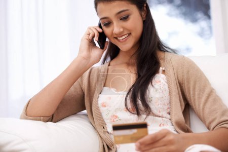 Photo for Happy woman, phone call and credit card for online shopping, payment or banking on sofa at home. Female person talking on mobile smartphone with smile for ecommerce, debit or conversation on account. - Royalty Free Image
