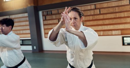 Photo for Students learning aikido, fitness and martial arts training class for self defense and discipline. Combat, fight and education, black belt with Japanese people and workout for exercise in dojo. - Royalty Free Image
