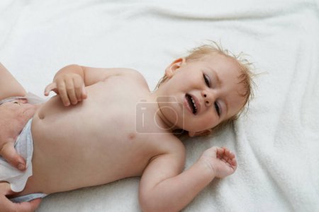 Photo for Sad, crying and baby boy at home, diaper and distress with naughty childhood personality. Problem, emotional and frustrated young kid, bedroom and toddler with development, body and changing. - Royalty Free Image