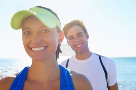 Photo for Happy couple, outdoor and portrait in beach, workout and fitness with smile, training and sunrise for run. Man, woman and athletic in ocean, sea and exercise together in summer, morning and young. - Royalty Free Image