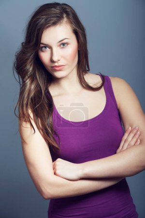 Photo for Woman, confidence and makeup in studio portrait, cosmetics and beauty on gray background. Female person, attitude and pride for hair and cool fashion, arms crossed and wellness or face by backdrop. - Royalty Free Image