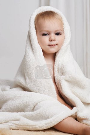 Photo for Portrait of baby on bed, clean with towel and bath in morning with health, wellness and growth in house. Cute happy toddler in bedroom for hygiene, relax or calm bedtime for child development in home. - Royalty Free Image