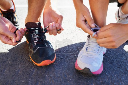 Photo for Shoes, hands and people tie laces for run, closeup for fitness and cardio outdoor, athlete team and workout. Training for race, marathon and runner group with sneakers, exercise and sports for health. - Royalty Free Image