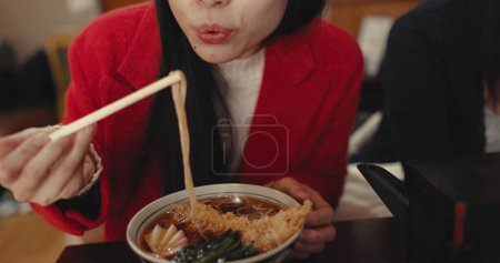 Photo for Woman, mouth and blowing ramen noodles in restaurant for dinner, diet and meal in cafeteria. Closeup, hungry lady and chopsticks for eating hot spaghetti, Japanese cuisine or lunch in fast food diner. - Royalty Free Image