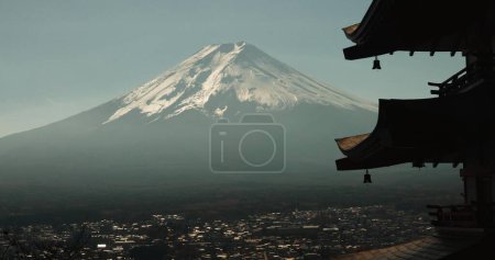 Photo for Chureito Pagoda, Mount Fuji and city in morning with temple, trees and blue sky on travel. Japanese architecture, culture and spiritual history with view of mountain, snow and calm Asian landscape - Royalty Free Image