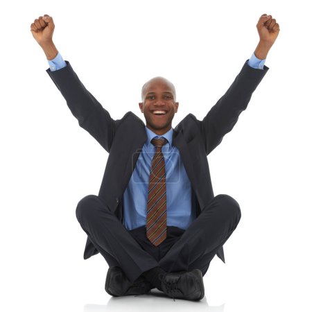 Photo for Happy businessman, portrait and fist pump for promotion, bonus or celebration on a white studio background. Excited black man or employee smile sitting on floor for winning, achievement or promo deal. - Royalty Free Image