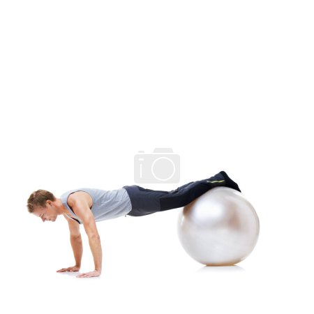 Photo for Man, fitness and exercise ball for workout, balance or health and wellness against a white studio background. Active male person or athlete on round object for training or pilates on mockup space. - Royalty Free Image